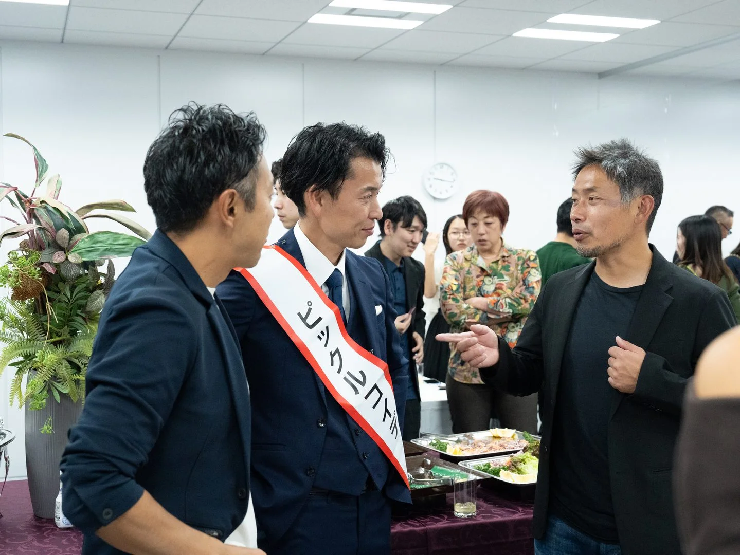 2025年の授賞式会場で参加者が会話する様子